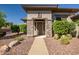 Inviting front entrance framed by stone pillars and desert landscaping with a neutral-colored facade at 1557 W Laurel Greens Ct, Anthem, AZ 85086
