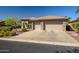 Spacious three-car garage accented with stone pillars and a large driveway at 1557 W Laurel Greens Ct, Anthem, AZ 85086