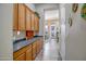 Hallway featuring lots of storage and counter space leading to the kitchen and breakfast nook at 1557 W Laurel Greens Ct, Anthem, AZ 85086