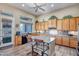 Bright kitchen with natural wood cabinets, a center island, and modern appliances at 1557 W Laurel Greens Ct, Anthem, AZ 85086