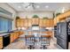 Spacious kitchen features an island with seating, stainless steel appliances, and ample storage cabinets at 1557 W Laurel Greens Ct, Anthem, AZ 85086