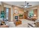 Cozy living room with a fireplace, built-in media center, and comfortable seating at 1557 W Laurel Greens Ct, Anthem, AZ 85086