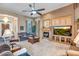 Inviting living room features a fireplace, ceiling fan and comfortable seating arrangement at 1557 W Laurel Greens Ct, Anthem, AZ 85086