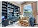 An office featuring built-in bookshelves and a comfortable seating area at 1557 W Laurel Greens Ct, Anthem, AZ 85086