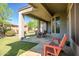 Spacious patio features stone flooring, ample seating, and views of the lush, green backyard, perfect for outdoor living at 1557 W Laurel Greens Ct, Anthem, AZ 85086