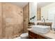 Bathroom features travertine stone walls, a wood cabinet, and vessel sink at 17012 N 57Th St, Scottsdale, AZ 85254