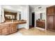 Well-lit bathroom showcasing double vanities with wood cabinets, a large mirror, and tile flooring at 17012 N 57Th St, Scottsdale, AZ 85254