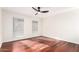 Bright bedroom features striking wood floors, modern ceiling fan, and dual pane windows at 17012 N 57Th St, Scottsdale, AZ 85254
