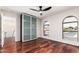 Bright bedroom boasts hardwood floors, a modern ceiling fan, and large windows providing ample natural light at 17012 N 57Th St, Scottsdale, AZ 85254