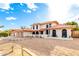 Exterior elevation of a home with two car garage, desert landscaping and red-tile roof at 17012 N 57Th St, Scottsdale, AZ 85254