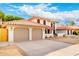 Two-car garage with extended driveway and red tile roof, desert landscaping in front yard at 17012 N 57Th St, Scottsdale, AZ 85254