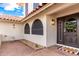 Front door of a home with wreath, and desert landscaping elements in front yard at 17012 N 57Th St, Scottsdale, AZ 85254