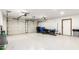 Spacious two-car garage with painted floor, tool storage and access door to the side at 17012 N 57Th St, Scottsdale, AZ 85254