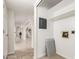 Bright hallway featuring tiled floors, an electrical panel, and access to the rest of the home at 17012 N 57Th St, Scottsdale, AZ 85254
