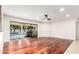 Bright living room with hardwood floors, sliding glass doors to pool, and recessed lighting at 17012 N 57Th St, Scottsdale, AZ 85254