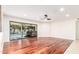 Bright living room with hardwood floors, sliding glass doors to pool, and recessed lighting at 17012 N 57Th St, Scottsdale, AZ 85254