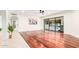 Spacious living room with hardwood floors, sliding glass doors to pool, modern ceiling fan at 17012 N 57Th St, Scottsdale, AZ 85254