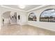 Living room featuring tile floors, an arched entryway, and views to exterior at 17012 N 57Th St, Scottsdale, AZ 85254