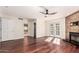 Bright living room features striking wood floors, modern ceiling fan, fireplace, and arched doors at 17012 N 57Th St, Scottsdale, AZ 85254