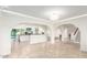Open concept living space with arched doorways, tile flooring and modern light fixtures at 17012 N 57Th St, Scottsdale, AZ 85254