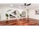 Bright living room featuring arched doorways, hardwood floors, and staircase at 17012 N 57Th St, Scottsdale, AZ 85254