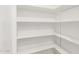 This home's pantry is clean and organized with white shelving at 17012 N 57Th St, Scottsdale, AZ 85254