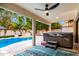Hot tub on covered patio featuring an outdoor ceiling fan and views of the pool and backyard at 17012 N 57Th St, Scottsdale, AZ 85254