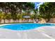 Beautiful pool featuring rock detail, manicured landscaping and a blue umbrella under a bright, partly cloudy sky at 17012 N 57Th St, Scottsdale, AZ 85254