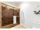 Modern bathroom featuring a tiled shower with glass doors, complemented by neutral wall decor at 17012 N 57Th St, Scottsdale, AZ 85254