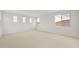 Spacious carpeted bedroom features four windows letting in natural light at 17643 W Rancho Dr, Litchfield Park, AZ 85340