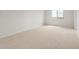 Neutral carpeted bedroom has large window with view and base trim at 17643 W Rancho Dr, Litchfield Park, AZ 85340