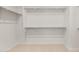Walk-in closet with carpet and shelving ready for organization at 17643 W Rancho Dr, Litchfield Park, AZ 85340
