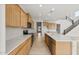 Spacious open-concept kitchen featuring white countertops, stainless appliances, and wooden cabinets at 17643 W Rancho Dr, Litchfield Park, AZ 85340