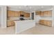 Bright kitchen featuring a large island, stainless steel appliances, and ample cabinet space at 17643 W Rancho Dr, Litchfield Park, AZ 85340