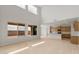 Bright, open-concept living area featuring wood-look floors, large windows, and an open kitchen at 17643 W Rancho Dr, Litchfield Park, AZ 85340