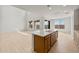 Open-concept living and kitchen area with white countertops, wood cabinets, and large windows at 17643 W Rancho Dr, Litchfield Park, AZ 85340