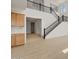 Open-concept living area with a staircase and light wood-look tile floors at 17643 W Rancho Dr, Litchfield Park, AZ 85340