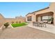 A well-manicured backyard offers outdoor dining and a low-maintenance landscape at 17913 W Sunward Dr, Goodyear, AZ 85338