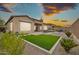 Backyard showcases a lush green lawn, patio area, and comfortable outdoor seating area at 17913 W Sunward Dr, Goodyear, AZ 85338