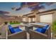 Relaxing backyard featuring a spa, outdoor seating area, lush turf, and privacy wall, perfect for outdoor living at 17913 W Sunward Dr, Goodyear, AZ 85338