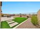 Large backyard with green turf, a dining set, hot tub, and outdoor lounge at 17913 W Sunward Dr, Goodyear, AZ 85338