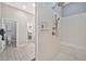 Bathroom with tiled flooring and standing shower, and an attached water closet and walk-in closet at 17913 W Sunward Dr, Goodyear, AZ 85338