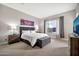 Bright bedroom boasts a large window, stylish gray curtains, and comfortable decor at 17913 W Sunward Dr, Goodyear, AZ 85338