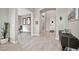 Bright foyer featuring neutral tones, stylish tile flooring, an arched entryway, and a modern console table at 17913 W Sunward Dr, Goodyear, AZ 85338
