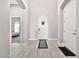 Elegant foyer showcasing neutral walls, light tile flooring, an arched doorway, and a statement front door at 17913 W Sunward Dr, Goodyear, AZ 85338
