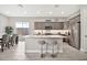Modern kitchen with a central island, stainless steel appliances, and an adjacent dining area at 17913 W Sunward Dr, Goodyear, AZ 85338