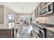 Modern kitchen with stainless steel appliances, sleek countertops, and a view of the backyard patio at 17913 W Sunward Dr, Goodyear, AZ 85338
