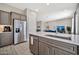 Bright kitchen with stainless steel appliances, quartz countertops, and view of the living room at 17913 W Sunward Dr, Goodyear, AZ 85338