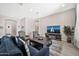 Inviting living room featuring cozy seating, a modern TV stand, and ample natural light, perfect for relaxation at 17913 W Sunward Dr, Goodyear, AZ 85338