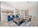 Cozy living room showcasing an open floor plan with a glimpse into the modern kitchen and dining area at 17913 W Sunward Dr, Goodyear, AZ 85338